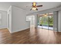 Bright living room with wood floors and sliding glass doors at 8362 Bella Tierra Ct, Davenport, FL 33896