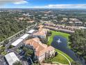 Aerial view of a community with lake, landscaping, and condo buildings at 8298 Portofino Dr # 202, Davenport, FL 33896