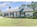 Updated single story home with dark garage door at 6341 Edge O Grove Cir, Orlando, FL 32819