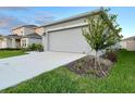 One-story house with a two-car garage at 1393 Asher Mason Ave, Kissimmee, FL 34744
