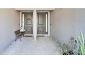 Covered entryway with double doors and a small sitting area at 593 Lake Wildmere Cv, Longwood, FL 32750