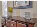 Console table with decorative vase and framed sign at 221 Las Fuentes Dr, Kissimmee, FL 34746