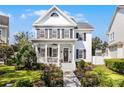 Two-story house with gray exterior, black shutters, porch, and landscaped yard at 805 Veranda Pl, Celebration, FL 34747