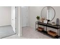 Bright and airy entryway with tile floors and modern console table at 4117 Giorgio Dr, Winter Haven, FL 33884