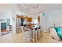 Kitchen with island, stainless steel appliances, and wood cabinets at 17833 Woodcrest Way, Clermont, FL 34714