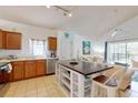 Kitchen with island, stainless steel appliances, and wood cabinets at 17833 Woodcrest Way, Clermont, FL 34714
