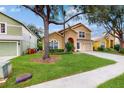 Two story house with front yard and driveway at 17833 Woodcrest Way, Clermont, FL 34714