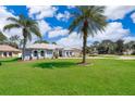 Two-story home with palm trees and a landscaped yard at 12009 Eagle Point Ct, Leesburg, FL 34788