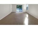 Spacious bedroom with carpeted floor and sliding glass door access to backyard at 309 Gina Ln, Davenport, FL 33837