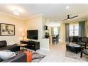Open living and kitchen area with neutral decor at 7582 Assembly Ln, Reunion, FL 34747