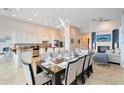 Open concept kitchen and dining area with stainless steel appliances and large island at 1169 Castle Pines Ct, Reunion, FL 34747