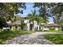 Two story luxury home with palm trees and circular driveway at 5121 Latrobe Dr, Windermere, FL 34786