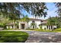 Two story luxury home with palm trees and circular driveway at 5121 Latrobe Dr, Windermere, FL 34786