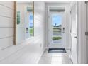 Bright entryway with shiplap walls, tile flooring, and mirrors at 2563 Sage Valley Way, Winter Haven, FL 33884