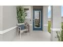Inviting front porch with a comfortable chair and stylish decor at 2563 Sage Valley Way, Winter Haven, FL 33884