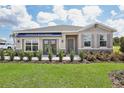 One-story home with gray siding, brown accents, and a two-car garage at 5945 Cliffbow Loop, Leesburg, FL 34748