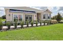 One-story home with gray siding, brown accents, and a two-car garage at 5945 Cliffbow Loop, Leesburg, FL 34748