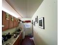 Galley-style kitchen with wood cabinets and granite countertops at 1051 E Patrick Cir, Daytona Beach, FL 32117