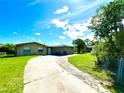 Ranch-style house with a curved driveway and grassy yard at 1051 E Patrick Cir, Daytona Beach, FL 32117