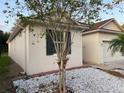 Side view of a one story house with white exterior and brown roof at 13038 Oulton Cir, Orlando, FL 32832