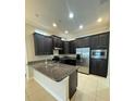 Kitchen with dark cabinetry, granite counters, and stainless steel appliances at 8282 Tavistock Lakes Blvd, Orlando, FL 32827