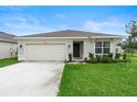 Newly built home with a two-car garage and curb appeal at 1220 Sugarwood St, Davenport, FL 33837