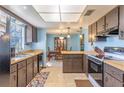 Kitchen with wood cabinets, light blue walls, and tile floor at 252 Cambridge Dr, Longwood, FL 32779