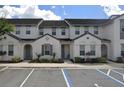 Modern townhome exterior, showcasing a gray facade and well-maintained landscaping at 314 Captiva Dr, Davenport, FL 33896