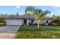 House exterior showcasing a gray roof, light brick facade, and a neatly landscaped front yard at 950 Amy Ridge Ct, Kissimmee, FL 34747