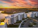 Aerial view of apartment buildings near a lake at sunset at 3161 Paradox Cir # 101, Kissimmee, FL 34746