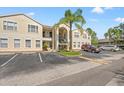 Condo building with multiple units and parking spaces in front at 8850 Grand Palms Circle # B, Kissimmee, FL 34747