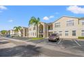 Condo building with multiple units and parking spaces in front at 8850 Grand Palms Circle # B, Kissimmee, FL 34747