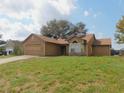 Tan house with a two-car garage and solar panels at 2618 Coventry Ln, Ocoee, FL 34761