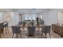 Modern dining area with wood table and gray patterned chairs at 2118 Cecile St, Kissimmee, FL 34741