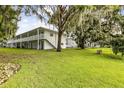 White building with balcony overlooking a grassy yard and mature trees at 320 Lakeview St # 100, Orlando, FL 32804