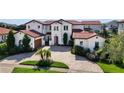 Mediterranean style home with tile roof and driveway at 15716 Panther Lake Dr, Winter Garden, FL 34787