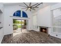 Living room with fireplace, wood floors and water view at 1000 Winderley Pl # 7, Maitland, FL 32751