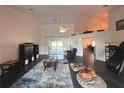 Spacious living room with hardwood floors, a fireplace, and large windows at 15701 Sw 37Th Cir, Ocala, FL 34473