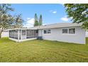 Home features a screened patio and a spacious backyard at 1925 Blossom Ln, Maitland, FL 32751