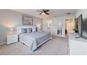 Main bedroom with king-size bed, ensuite bathroom access, and modern decor at 260 Jetty Way, Davenport, FL 33897