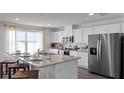 Modern kitchen with white cabinets, granite countertops, and stainless steel appliances at 2749 Flushing Dr, Apopka, FL 32703
