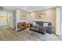 Living room with brown couch, wood floors, and modern decor at 1104 Spaceport Ct, Kissimmee, FL 34746