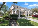 Two story tan townhome with red shutters and a paved driveway at 2364 Silver Palm Dr, Kissimmee, FL 34747