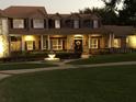 Evening view of home with lights and landscaping at 8000 Cherry Lake Rd, Groveland, FL 34736