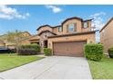 Two story house with brown garage door and green lawn at 5009 Torchwood Dr, Minneola, FL 34715