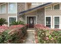 Welcoming entry with stone facade and lush landscaping at 202 Sweetwater Club Blvd, Longwood, FL 32779