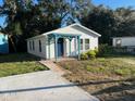 Newly renovated home exterior with a pergola and a blue front door at 0000 157Th St, Umatilla, FL 32784