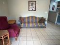 Cozy living room featuring a striped sofa and comfortable armchair at 0000 157Th St, Umatilla, FL 32784