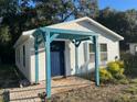 Quaint home exterior featuring a pergola and a blue front door at 0000 157Th St, Umatilla, FL 32784