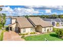 Lakefront home with two-car garage and landscaped yard at 621 E Wildmere Ave, Longwood, FL 32750